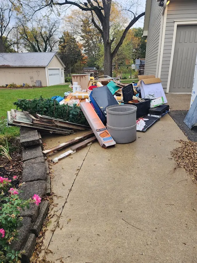 Dumpster being loaded with debris for Estate Cleanout Dumpster Rental in Walker